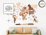 World map wall art in earthy tones displayed above a modern beige couch, featuring an illustration of a sandwich and a decorative emblem in the corner.
