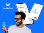 A smiling man holds a Monese card in front of a smartphone displaying the Monese app interface, set against a vibrant blue background. The image highlights the features of Monese, a mobile banking service.