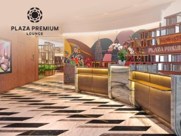 Modern interior of Plaza Premium Lounge featuring a stylish reception area with elegant decor, vibrant wall art, and polished flooring, designed for travelers seeking comfort and relaxation.