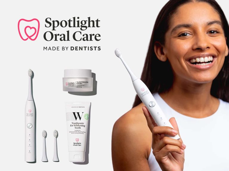 Smiling Woman Holding An Electric Toothbrush From Spotlight Oral Care, Featuring Dental Care Products Including Toothpaste And Whitening Treatments, Against A Clean White Background.