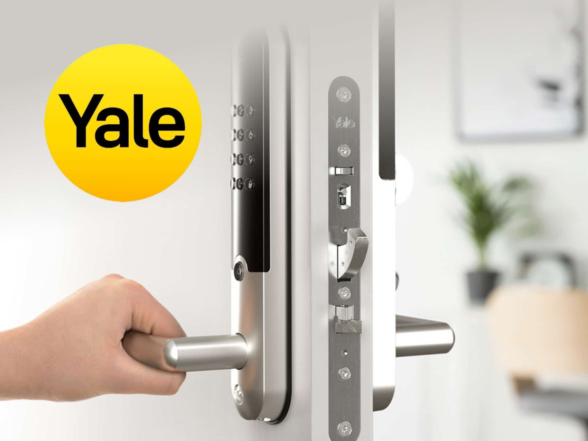 Close-up of a hand using a Yale smart lock on a modern door, showcasing the sleek design and advanced security features.
