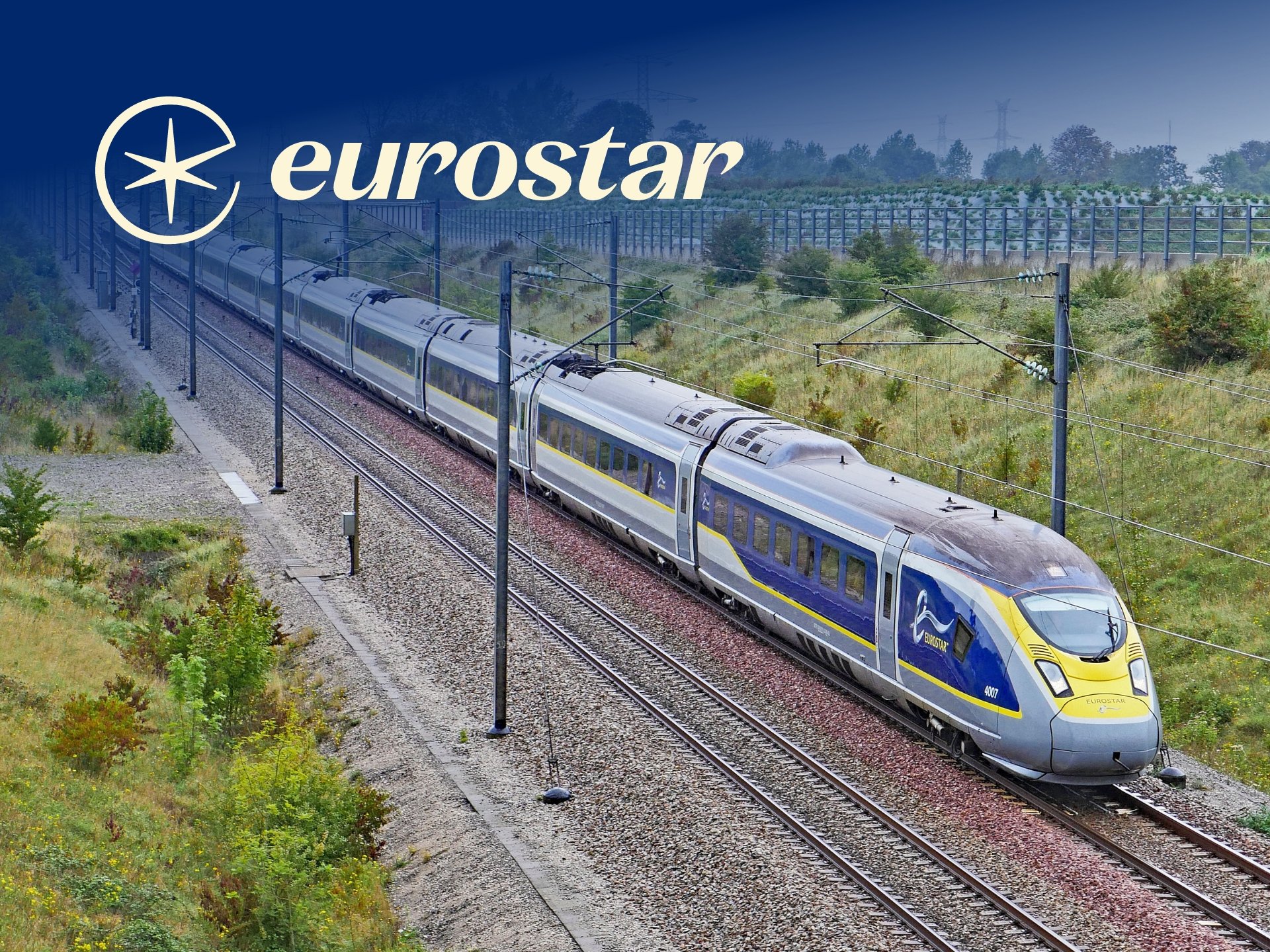 Eurostar High-Speed Train Traveling Through Lush Countryside, Showcasing Modern Rail Travel In Europe.