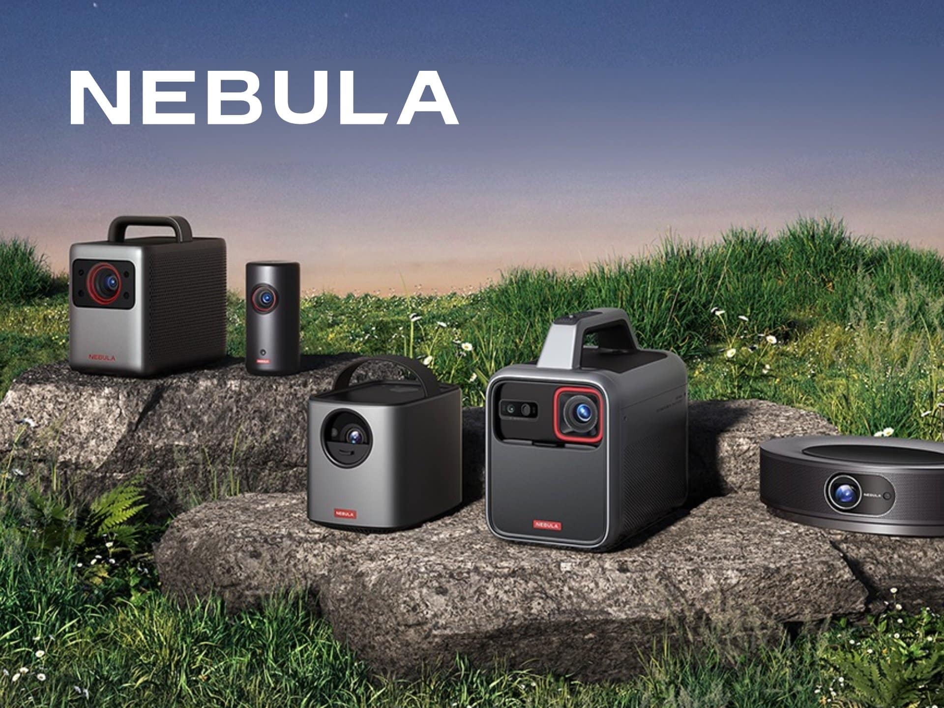 Nebula Portable Projectors Displayed Outdoors On A Grassy Area, Showcasing Their Sleek Designs And Versatility For Home Entertainment And Outdoor Movie Experiences.