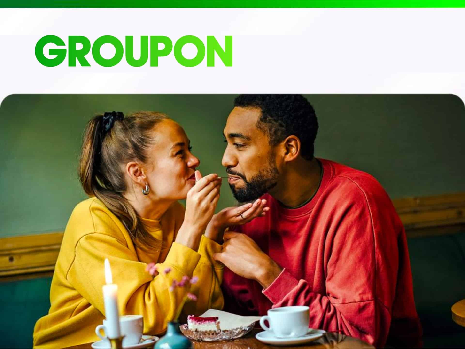 Couple sharing a sweet moment over coffee at a cozy café, with a Groupon logo displayed at the top, emphasizing romantic dining experiences.